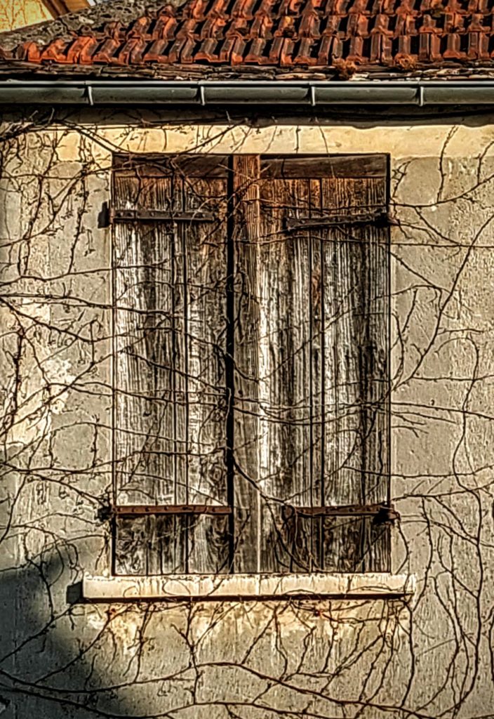a window on an old village house in Evecquemont, France